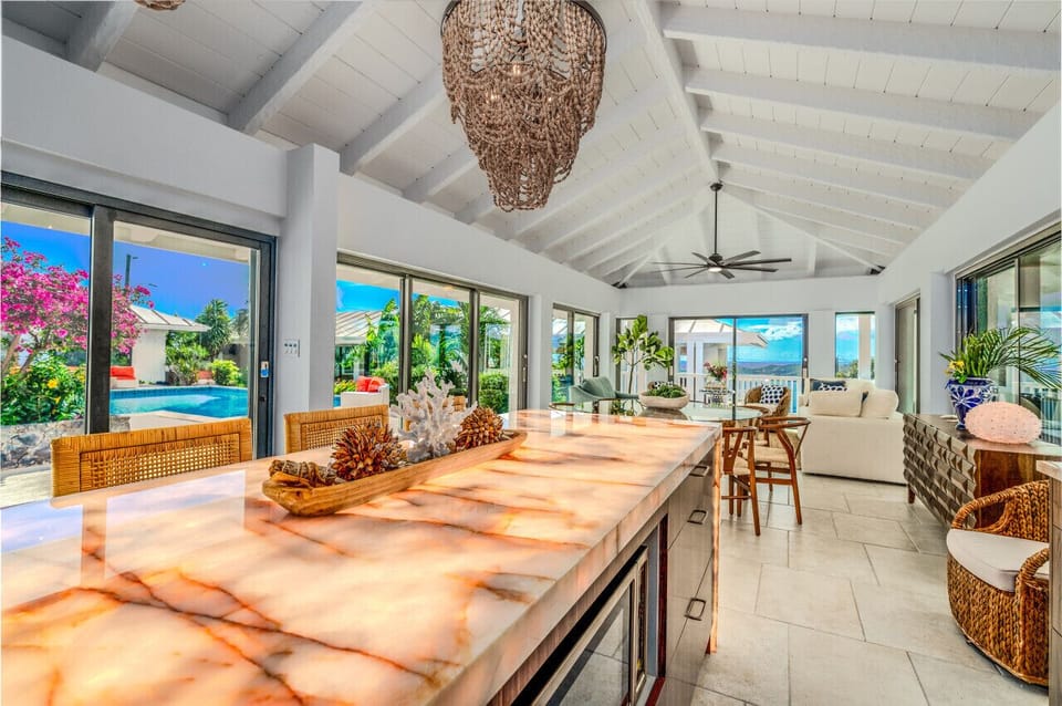 The incredible Fully air conditioned kitchen with underlit quartz island, indoor dining area, and indoor living room!