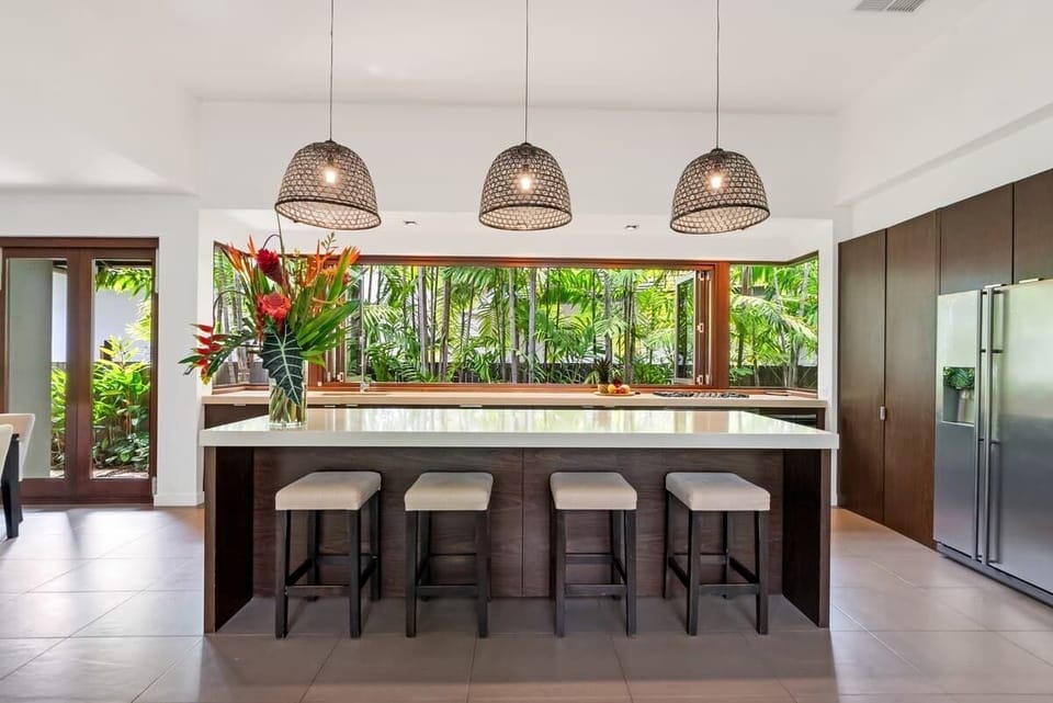 The state-of-the-art kitchen is a chef’s dream, equipped with Ilve appliances, Essa Stone benchtops, Italian Gessi taps, and timber cabinetry. 