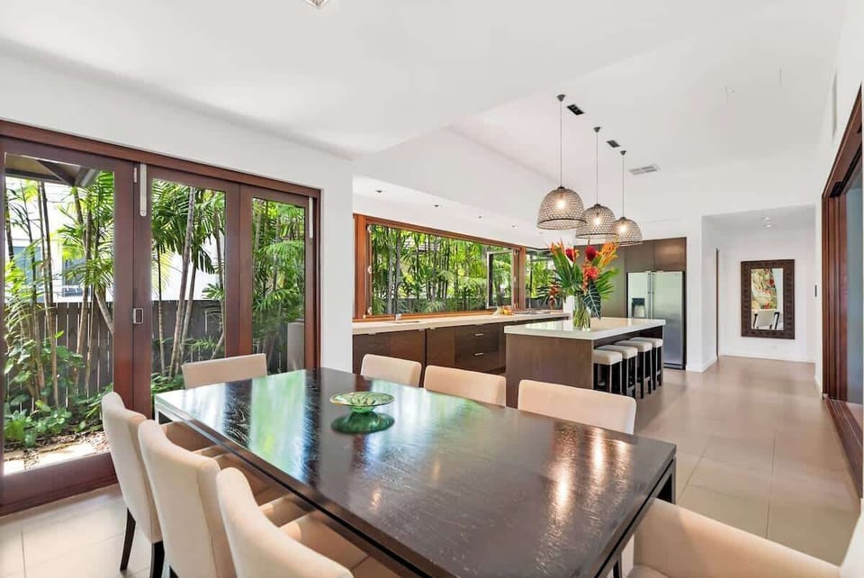 A timber dining table indoors provides the perfect setting for family meals, ideal for enjoying dishes made with the region's fresh produce.