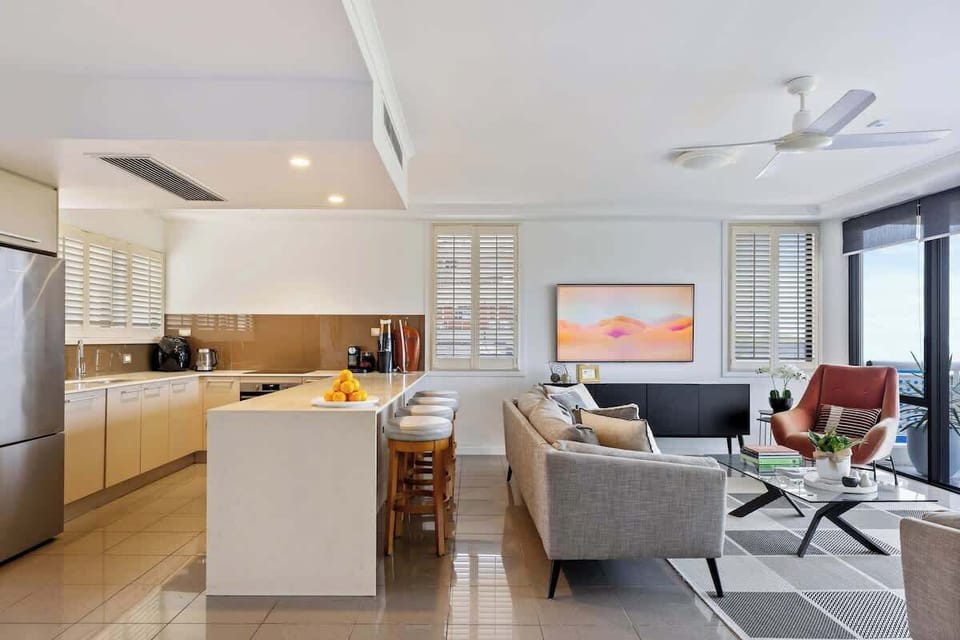 The living area opens up to a refreshing balcony for a breath of fresh air and is seamlessly connected to the kitchen for easy entertaining.