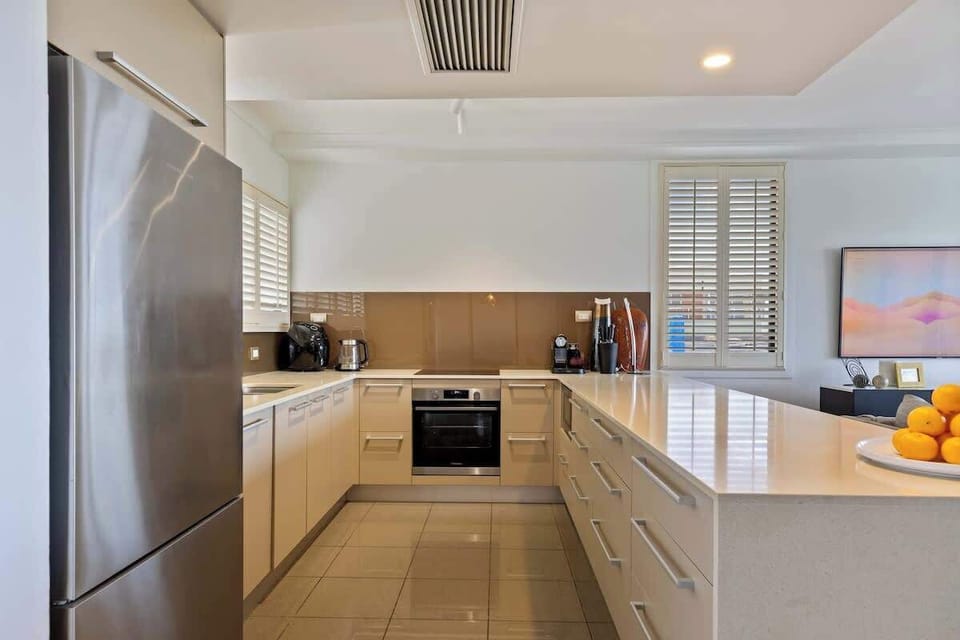 Holiday catering is a breeze in the full kitchen, designed around a breakfast bar.
