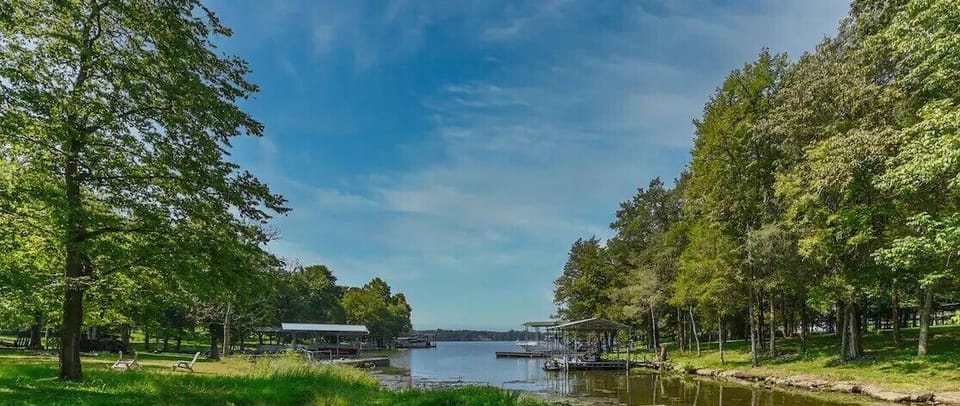 View from the edge of the property looking out into the open water. Shallow water averages 2 foot deep, give or take, depending upon what the dam and weather are doing. Perfect to kayak, canoe, fish or to just grab an inflatable to float out. 