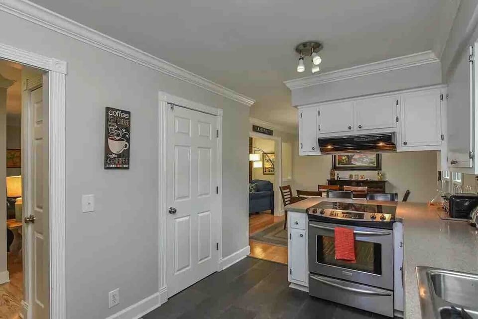 Door to left of stovetop is a small pantry with shelving. Between that space and the huge refrigerator...you'll be able to organize quickly and efficiently.