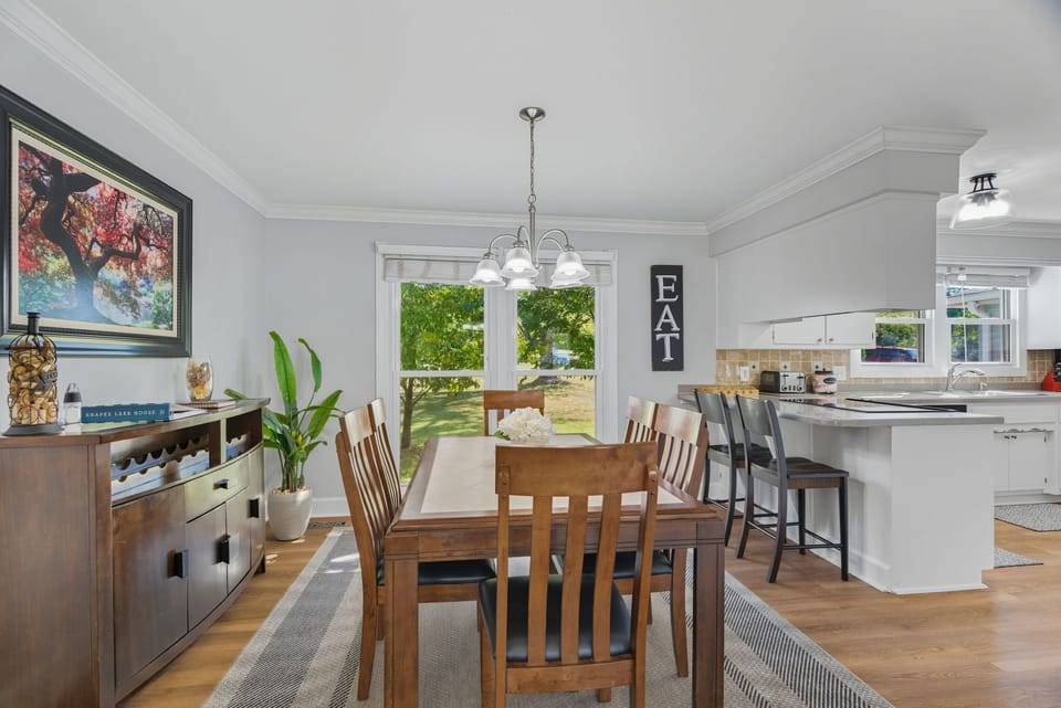 Seating for 6 around the table with 2 additional barstools at the adjacent kitchen counter.
