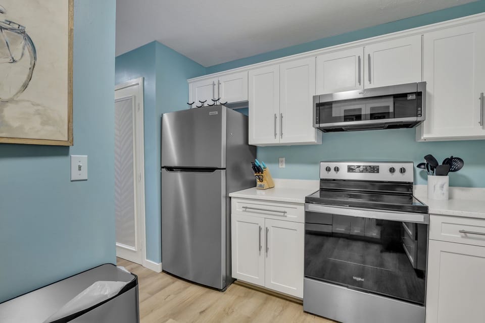 Fully stocked kitchen with stainless steel appliances .
