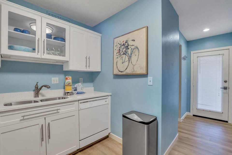 Fully stocked kitchen with stainless steel appliances .