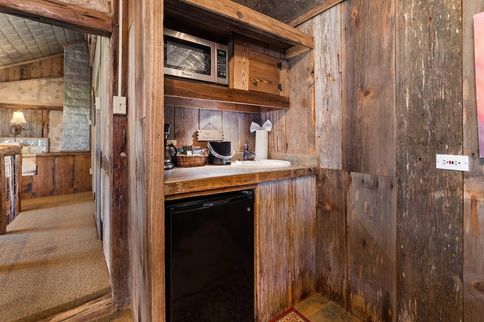 Experience the rustic charm of a coffee station and kitchenette in The Root Cellar, complete with a sink.