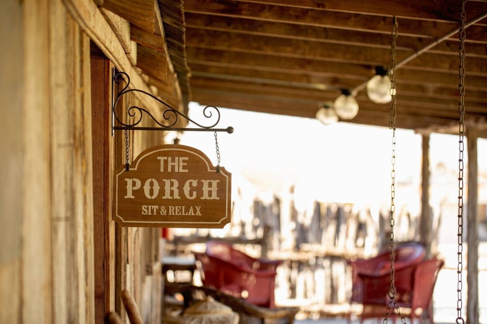 The porch seating area invites you to enjoy the fresh air and scenic surroundings, creating the perfect spot for conversation or savoring a quiet mome