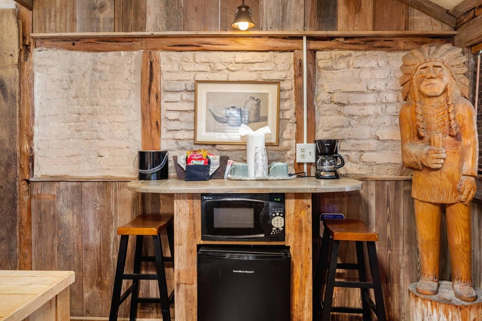 Enjoy the convenience of a small dinette area, complete with a coffee station, microwave, mini fridge, and barstools.
