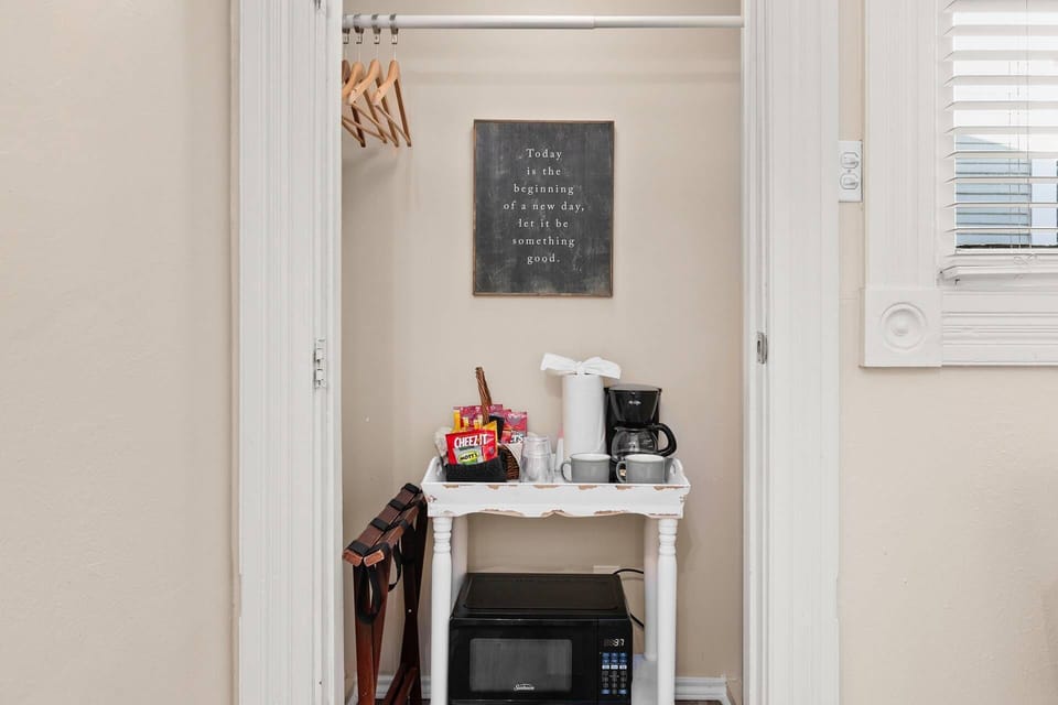 Picture a cozy corner equipped with the essentials – a coffee maker ready to brew your favorite blend and a microwave for quick and easy snacks.