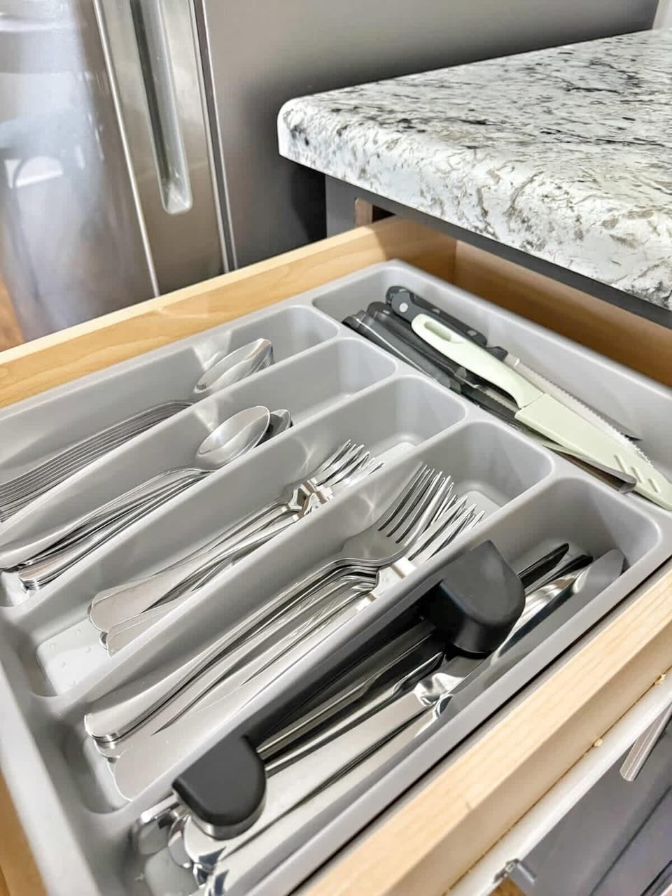 Fully stocked drawers with utensils, knives, and essentials