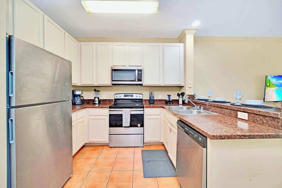 Fully equipped kitchen with silver appliances