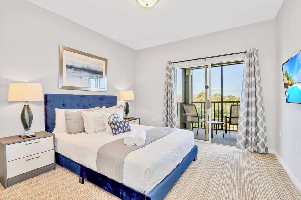 Queen bedroom with smart TV and outdoor patio access