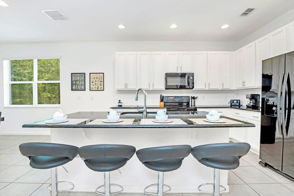 Fully Equipped Kitchen With A Spacious Island And Seating For Four