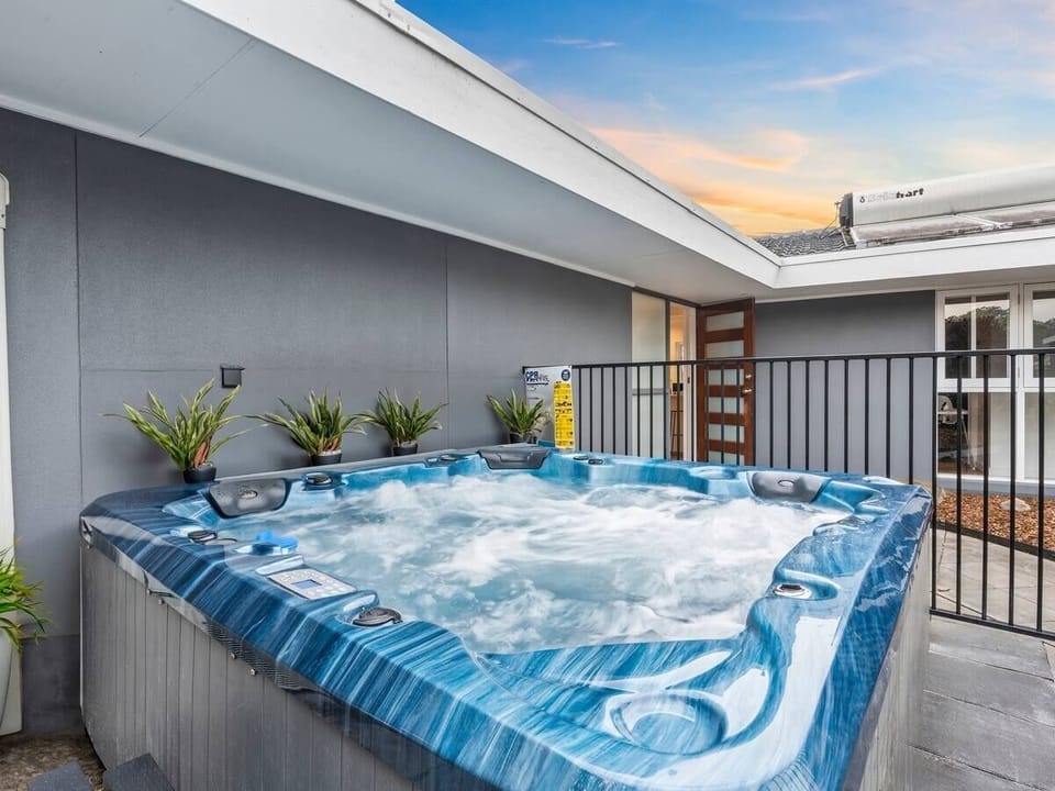Heated 3-seater spa with canal views for ultimate relaxation.
