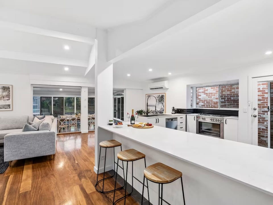 Modern gourmet kitchen with stone benchtops, Nespresso machine.