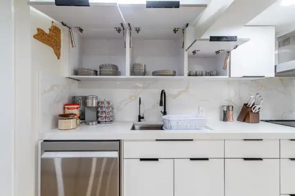 You'll find dinnerware, plates and cups in the overhead cupboards 