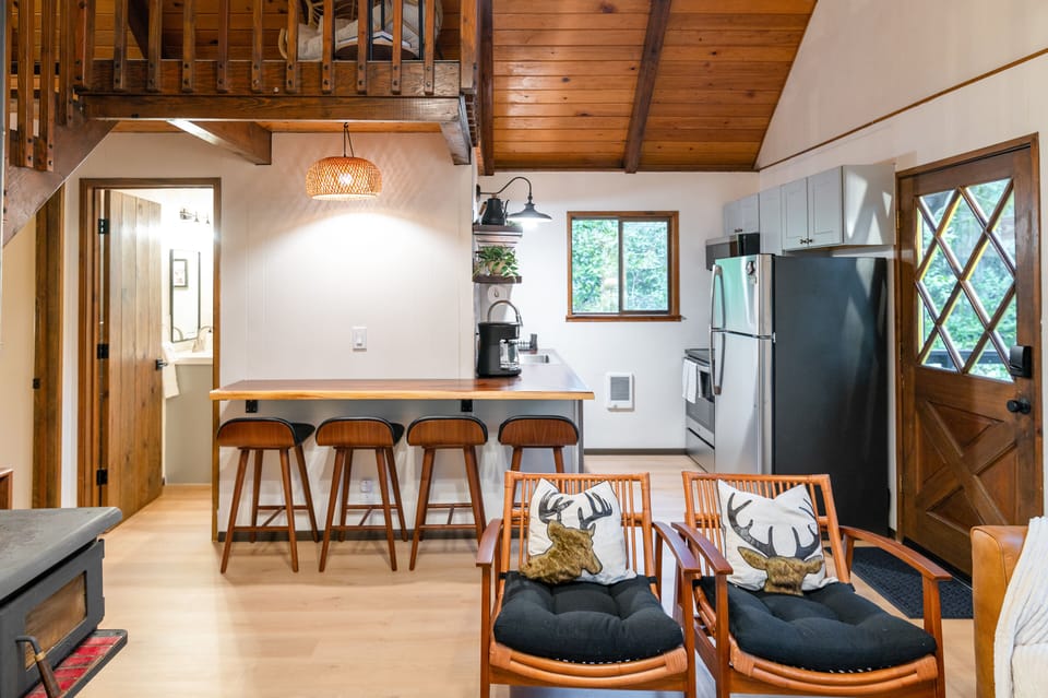 Dining space for four tucked between kitchen and living area.