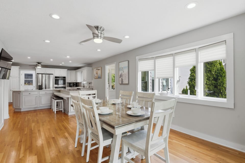 Gather around the table for shared meals before stepping out to the deck and pool beyond.