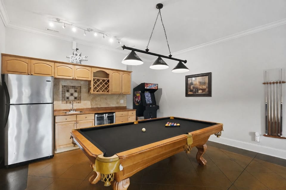Game-ready rec room with a pool table, arcade, and kitchenette for easy group hangouts.