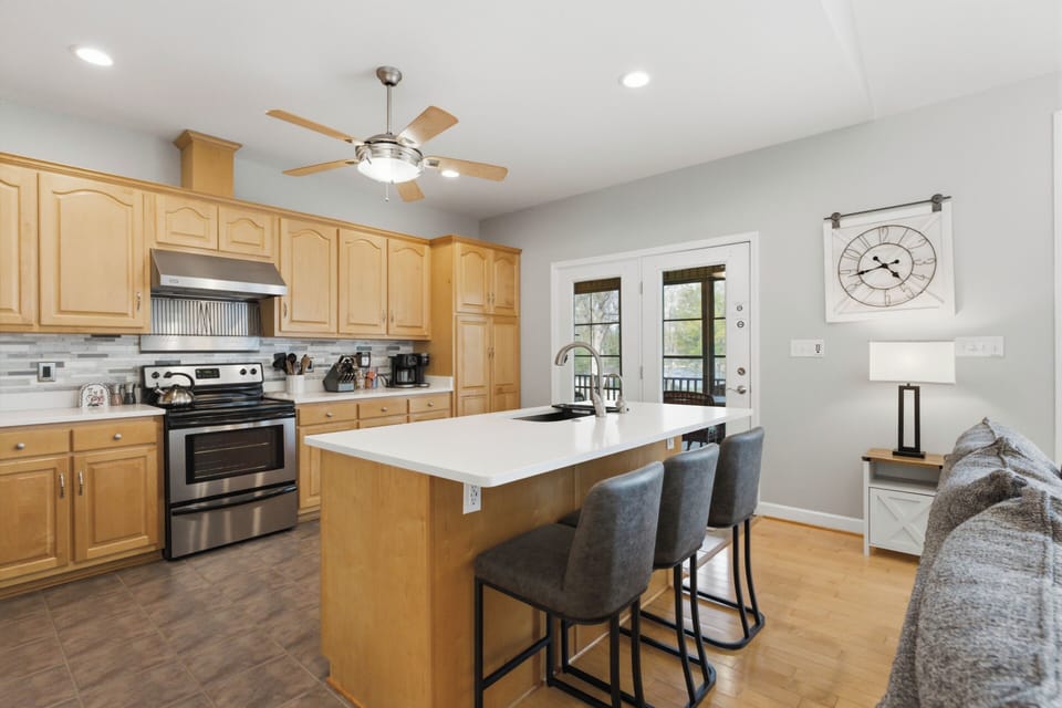 Updated kitchen with island featuring new countertops and backsplash. 