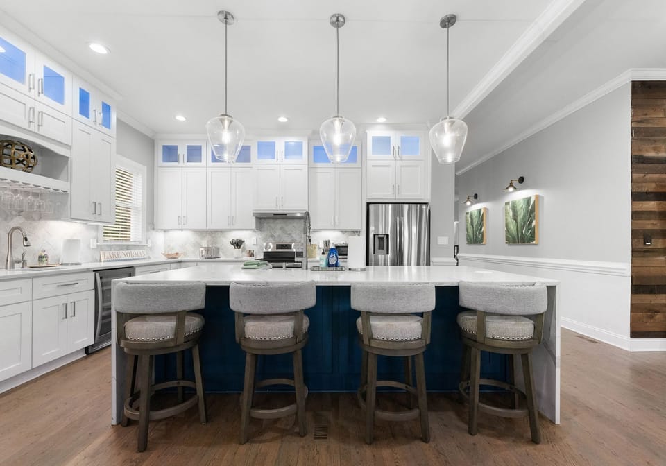 Open space kitchen with new, stainless, appliances.