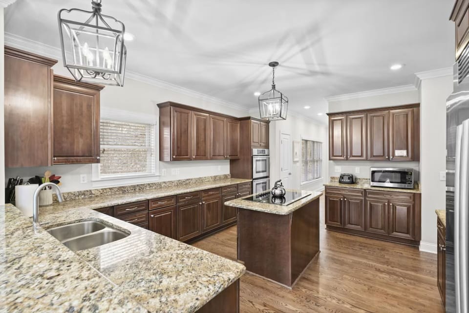 Upgraded kitchen, double ovens, industrial size refrigerator, island with built in stove