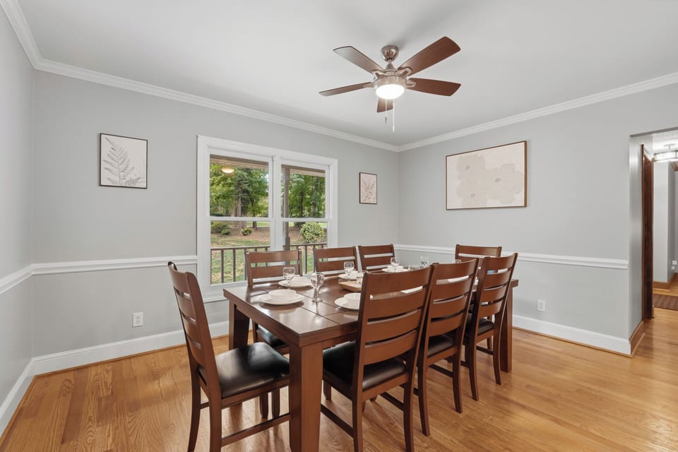 Bright dining room with peaceful backyard views through the windows.