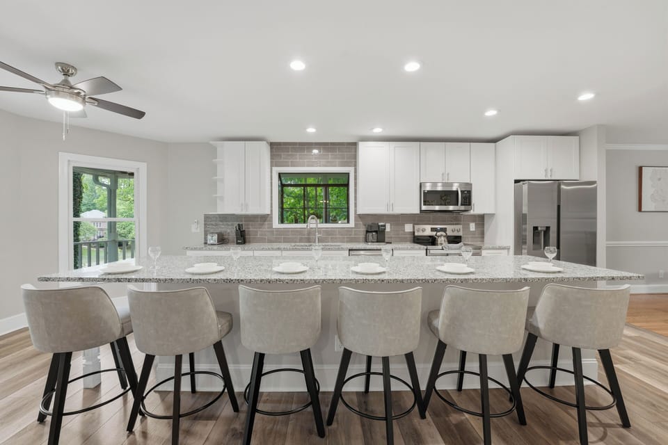 Spacious chef’s kitchen with oversized island seating and a bright, open layout made for gathering.
