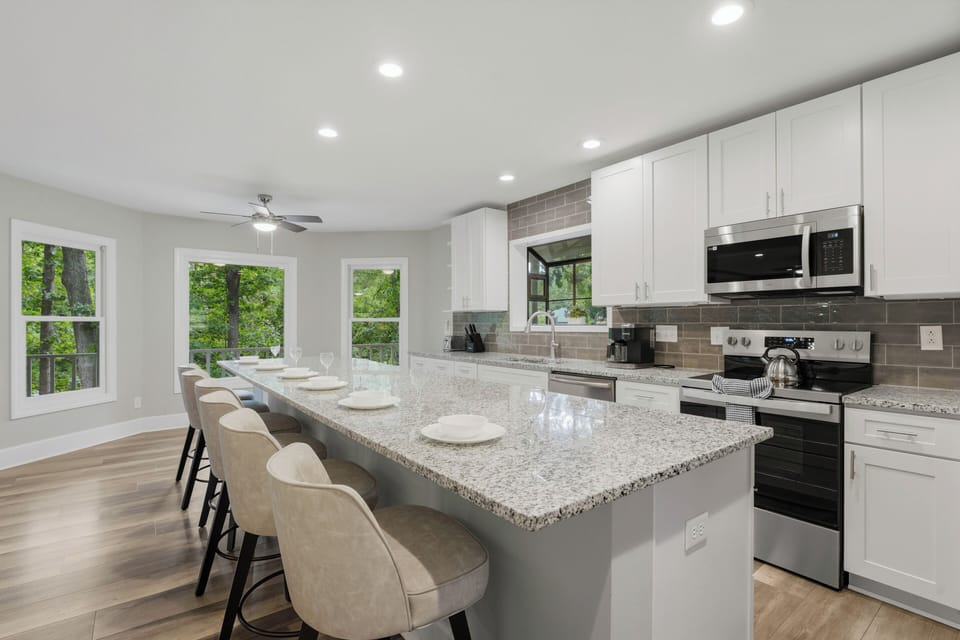 Spacious chef’s kitchen with oversized island seating and a bright, open layout made for gathering.