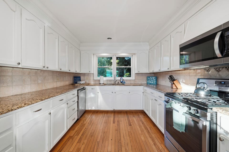 A fully equipped kitchen offers generous counter space, stainless steel appliances, and abundant cabinetry for easy meal prep.