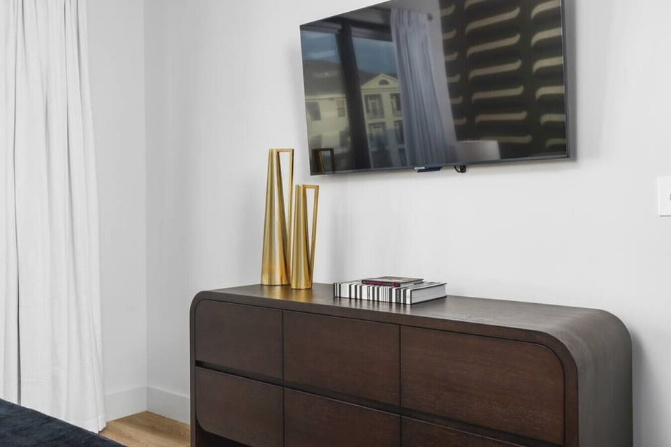 Primary bedroom's dresser and Smart TV.
