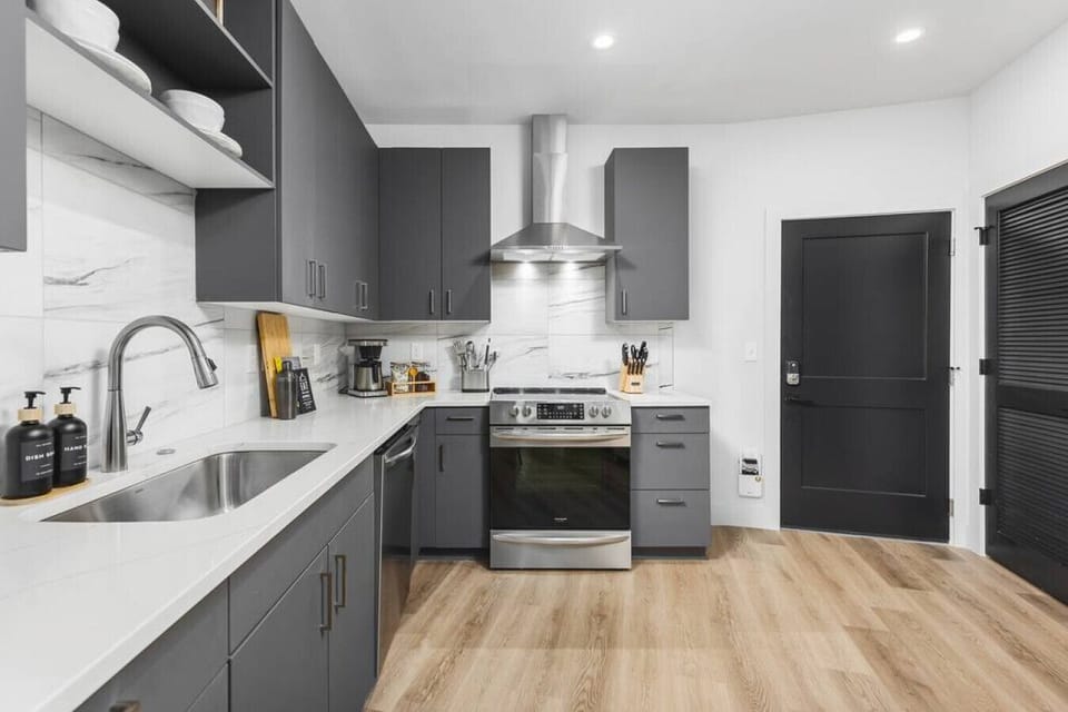 Fully-equipped kitchen with stainless steel appliances and every dish / utensil / tool you might need to enjoy a meal at home.