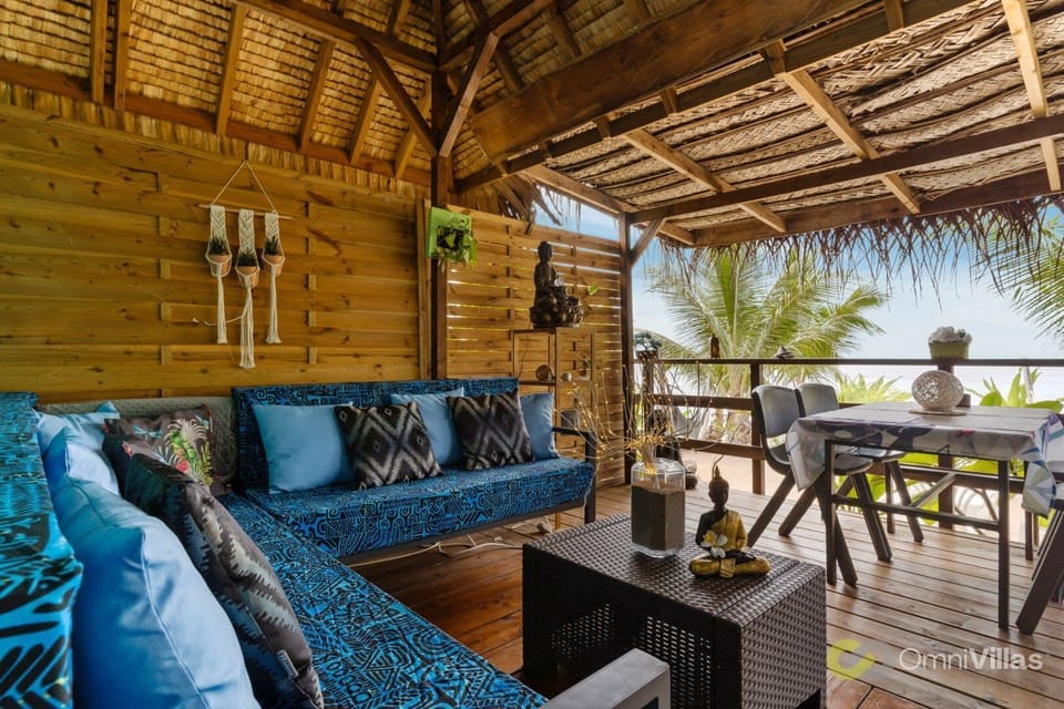 Shaded outdoor lounge with comfy seating and tropical wood design