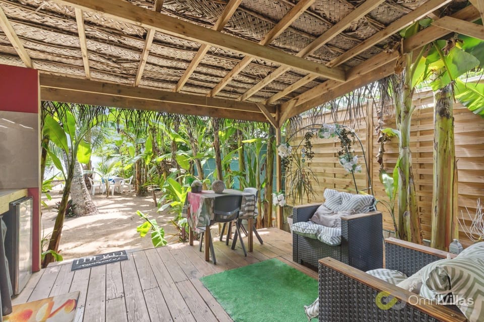 Large covered terrace with lounge seating.