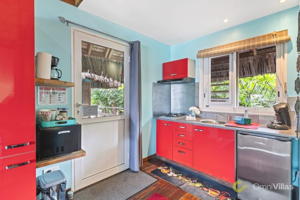 Bright kitchen with modern appliances and bold red cabinets