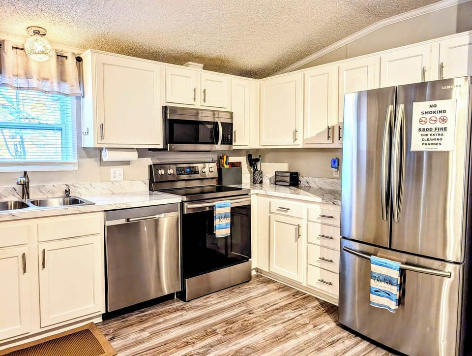 Kitchen: Prepare your meals with ease in our kitchen, featuring modern appliances and a spacious marble countertop.