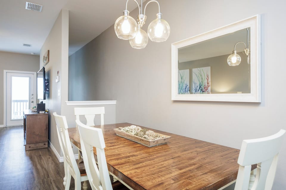 Gather around this beautiful rustic dining table where warm lighting creates the perfect atmosphere for memorable meals together.