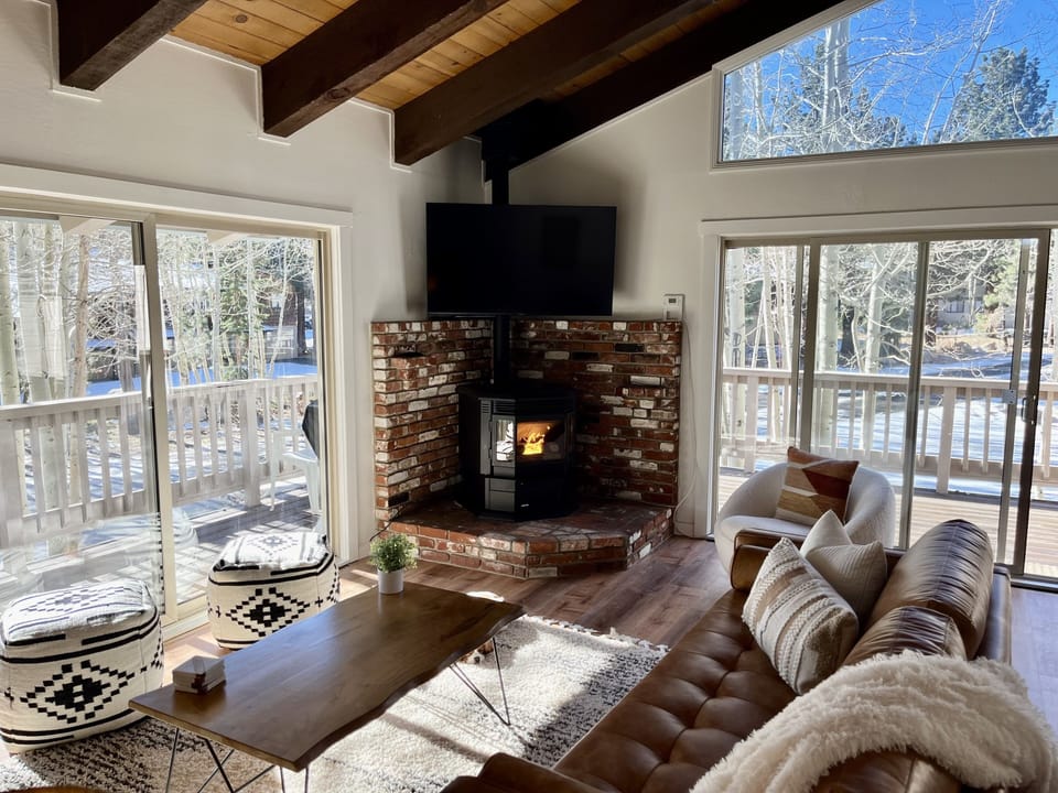 Bright living room with smart TV and pellet stove