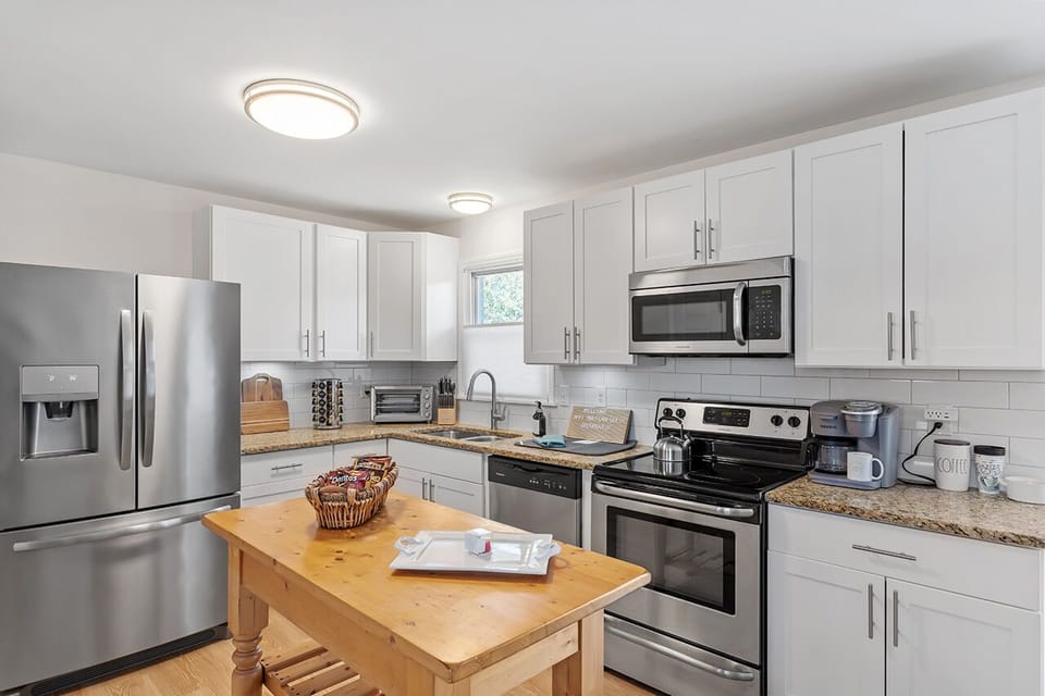 Indulge in the joy of cooking three meals a day in this splendidly remodeled kitchen, equipped with every conceivable tool, utensil, and baking essential.