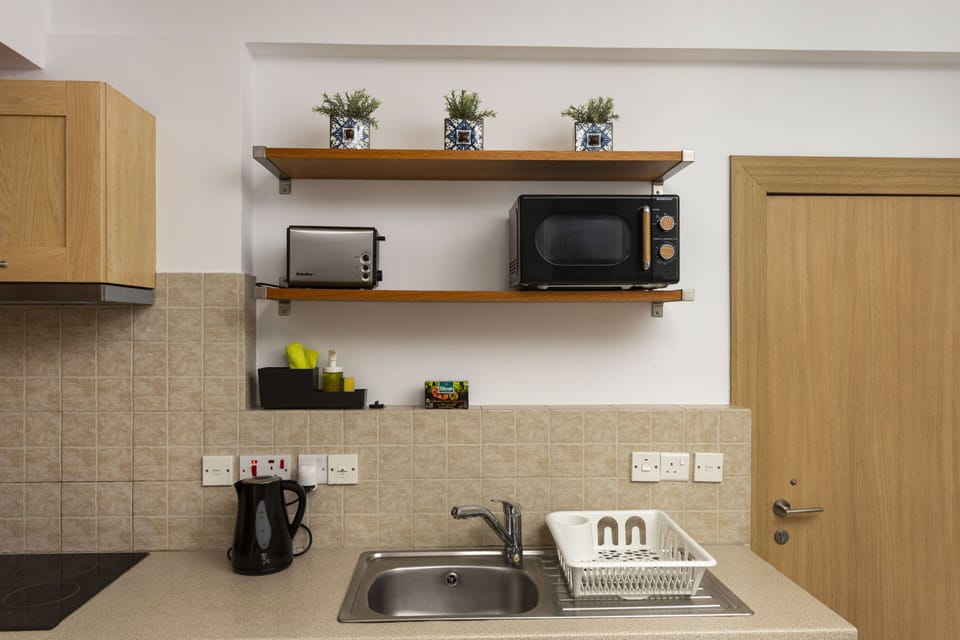 Comfort Apartment | Private kitchen | Full-size fridge, microwave, oven, stovetop