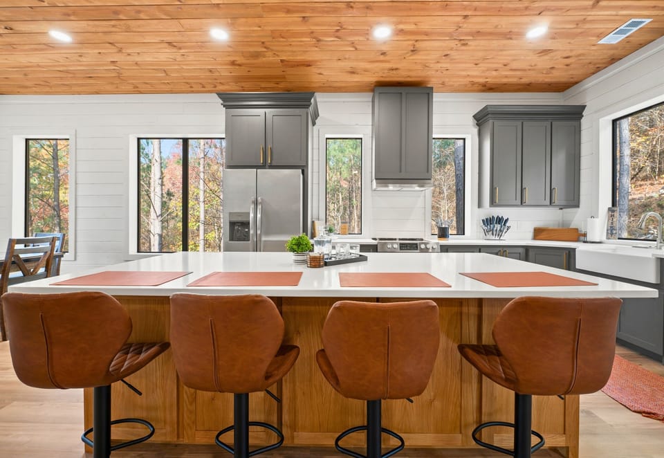 Heart of the Home: Share stories and savor meals at this inviting kitchen island, where rustic meets modern for a perfect family gathering spot.