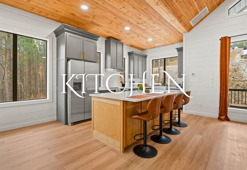 A kitchen that feels like a warm embrace, with wooden details and views that inspire you to create and indulge in the simple pleasures.