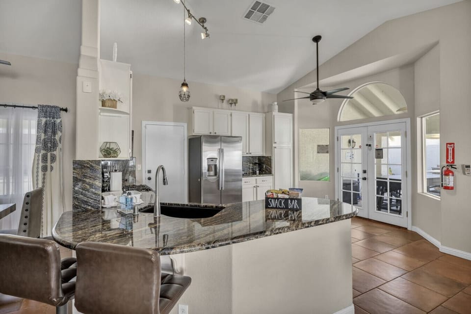 Create lasting memories with fun times at the breakfast bar, perfect for chats and snacks. Enjoy easy meal prep in the well-equipped kitchen and seamless indoor-outdoor flow to the patio.