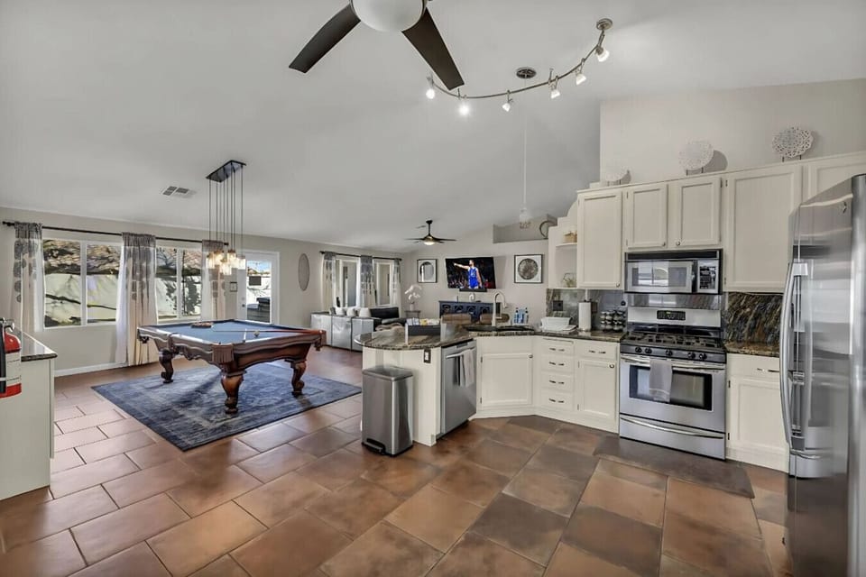 Enjoy exciting pool games for hours of friendly competition! The open layout makes it easy to socialize while preparing meals in the modern kitchen and relaxing in the spacious living area. It`s a hub for shared fun and memorable moments.