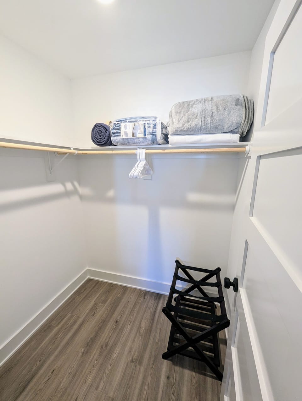 Luggage racks for your convenience in both king bedroom walk-in closets