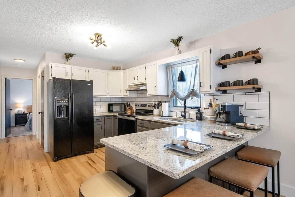 Full kitchen with Keurig duo coffee maker, refrigerator with ice maker and water dispenser, stainless steel range.  Equipped with bakeware, cookware, dinnerware, silverware and plenty of cups, glasses and coffee cups. 
