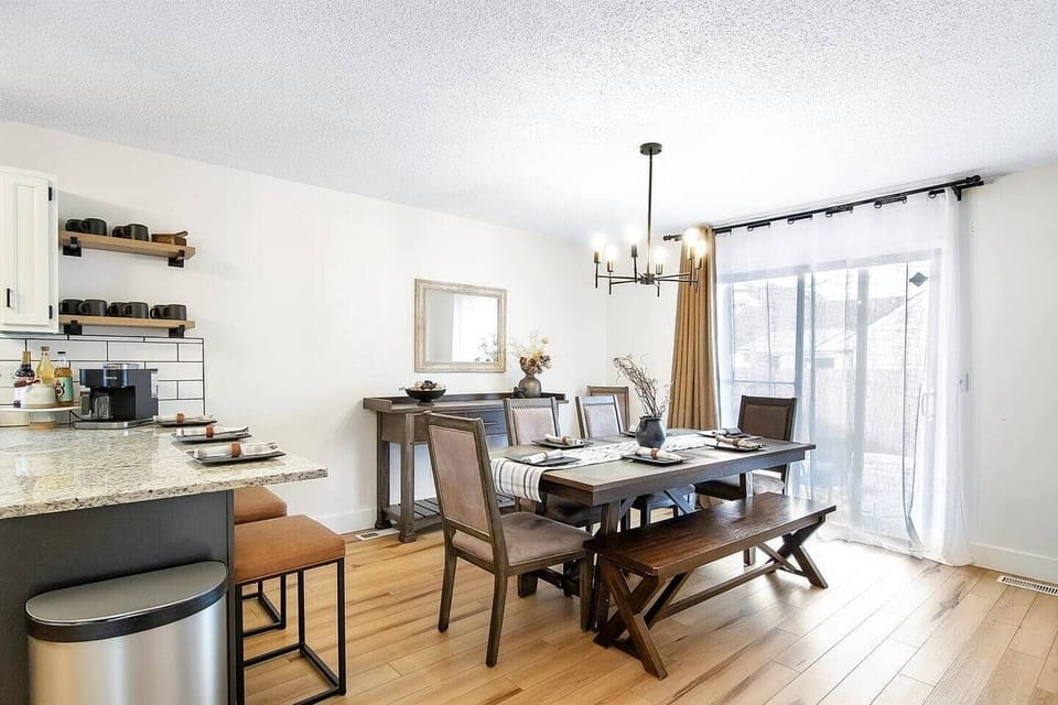 Dining room with large dining room table, bar and buffet. Patio doors opens onto new patio with Hot Tub