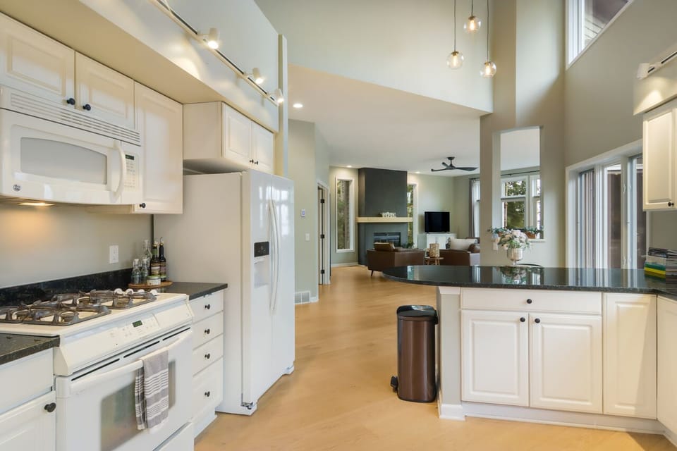Gas stove in kitchen, fully stocked with all kinds of cooking utensils. 