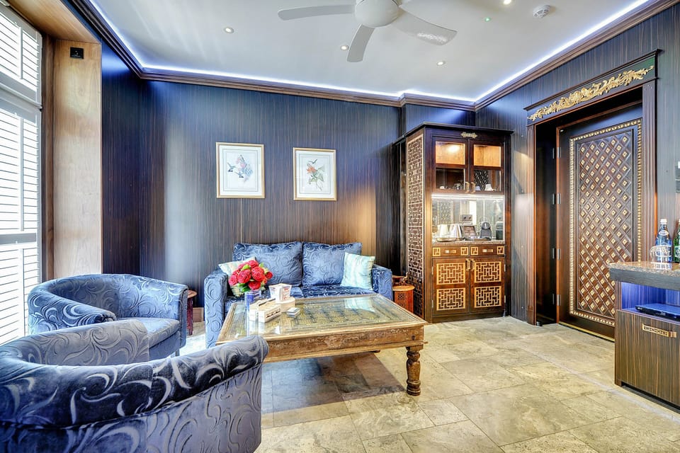 Deluxe Double Room | Living area | 40-inch LCD TV with cable channels, TV, smart speakers